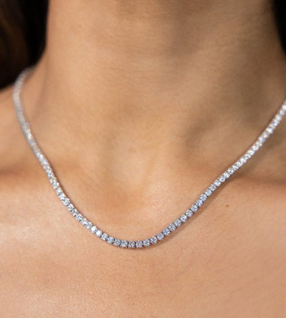 Close-up of a diamond necklace on a person's neck
